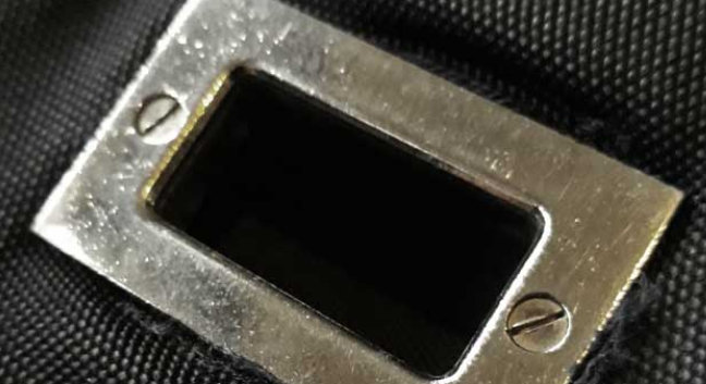 A flat Phillips screw head (-) on an authentic Gucci bag hardware